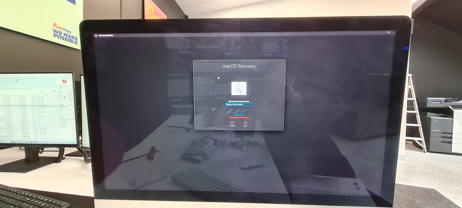 Apple iMac showing macOS Recovery sign-in screen in a Melbourne workplace